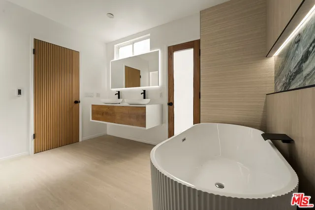 a en suite bathroom with a tub and sink