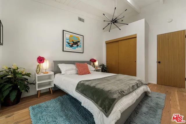 a bedroom with a bed and a dresser