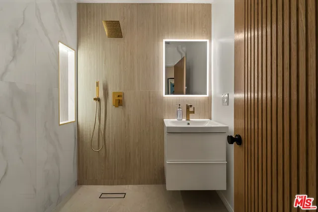 a bathroom with a sink and mirror