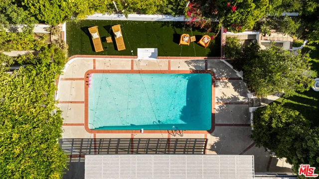 a view of a house with a big yard and sitting area