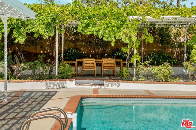 a view of a patio with table and chairs and potted plants