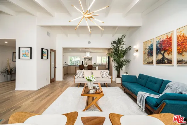 a living room with furniture ceiling fan and a rug