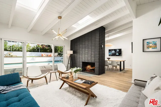 a living room with furniture a fireplace and a table