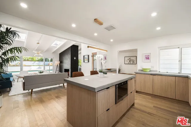 a kitchen with a stove and a large window