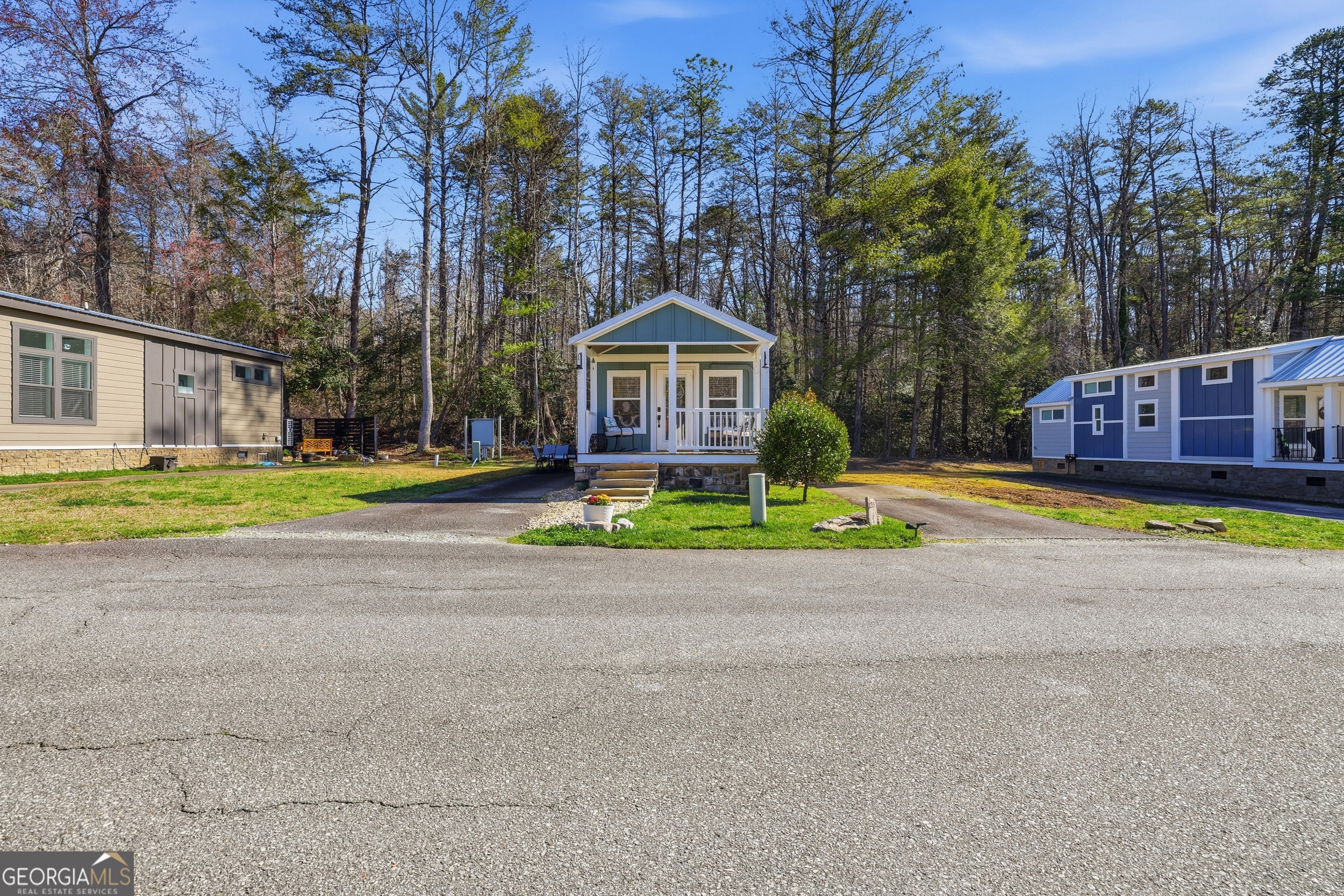 4960 Laurel Lodge Road, Unit 35 Clarkesville, GA 30523 - Photo 5 of 20 a view of a house with a small yard and a large tree