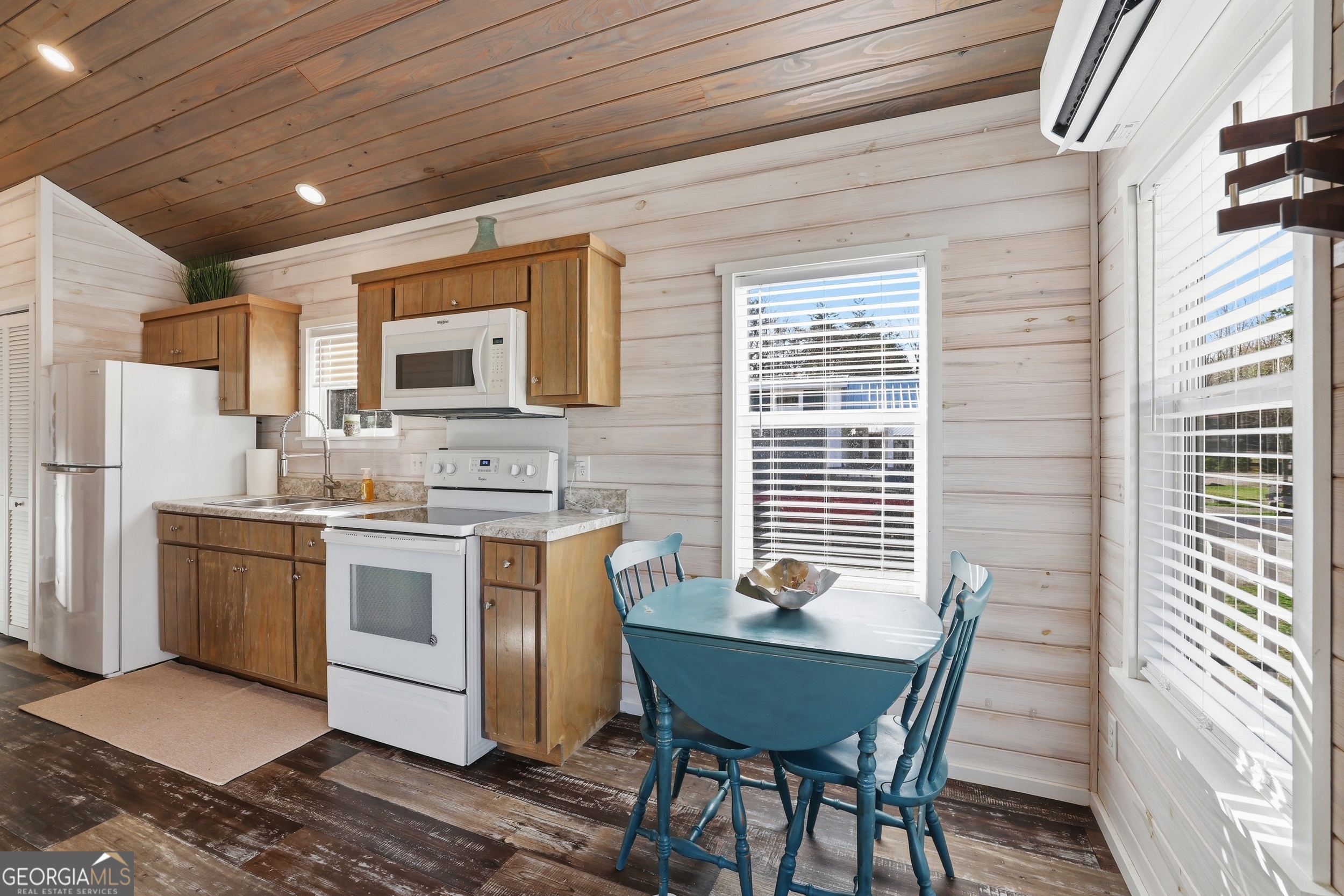 4960 Laurel Lodge Road, Unit 35 Clarkesville, GA 30523 - Photo 8 of 20 a open kitchen with stainless steel appliances granite countertop a stove a refrigerator a sink dishwasher with a dining table and chairs