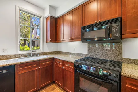 a large bed sitting in a spacious bedroom next to a window