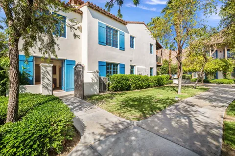 a view of a fountain in front of a brick house