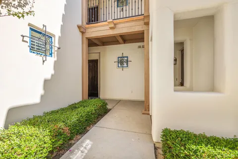 a living room with fireplace furniture and a large window