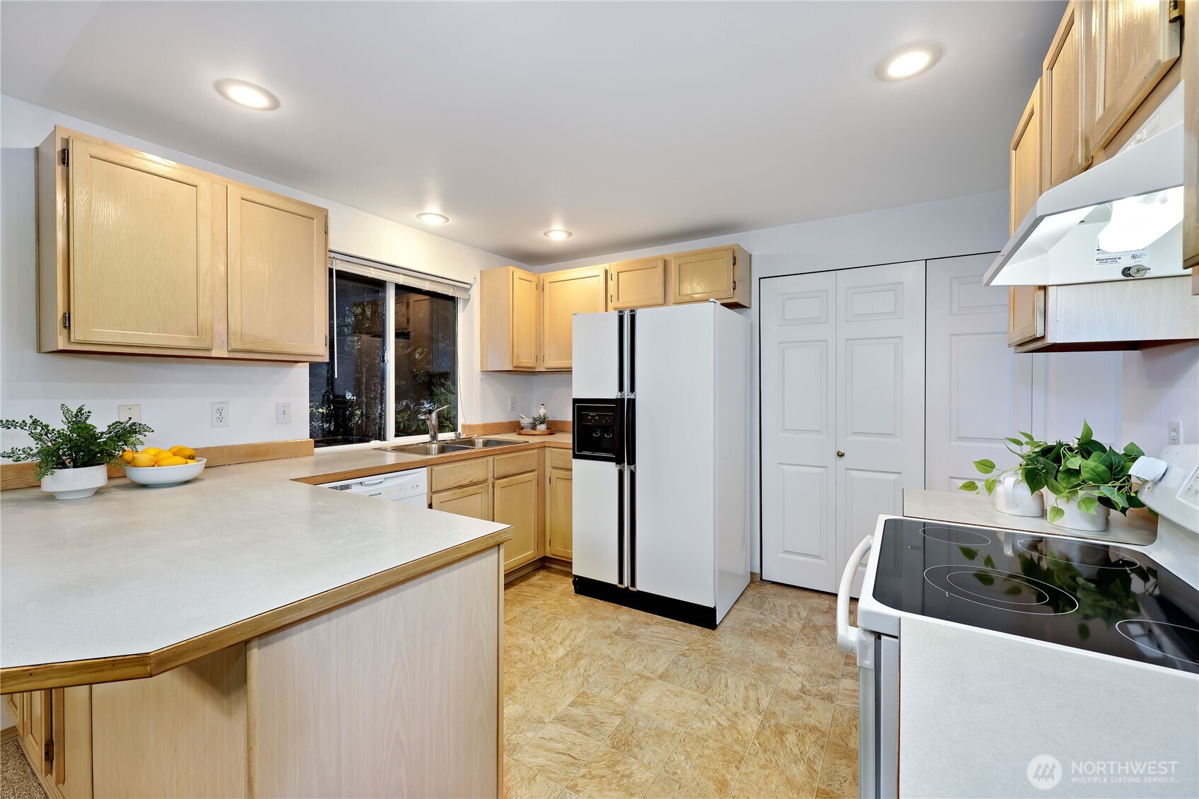 43 Rhody Court Chimacum, WA 98325 - Photo 17 of 37 a kitchen with stainless steel appliances a refrigerator sink and white cabinets