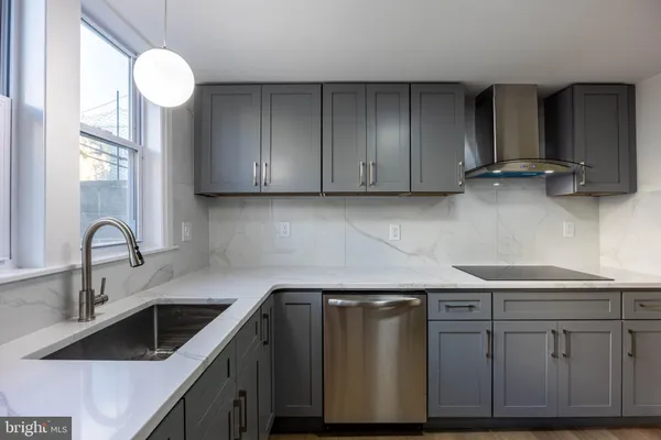 a kitchen with cabinets appliances and a sink