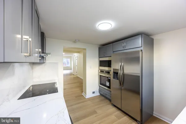 a kitchen with stainless steel appliances granite countertop a refrigerator and a sink
