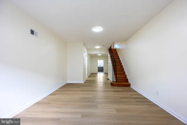 a view of a hallway with wooden floor