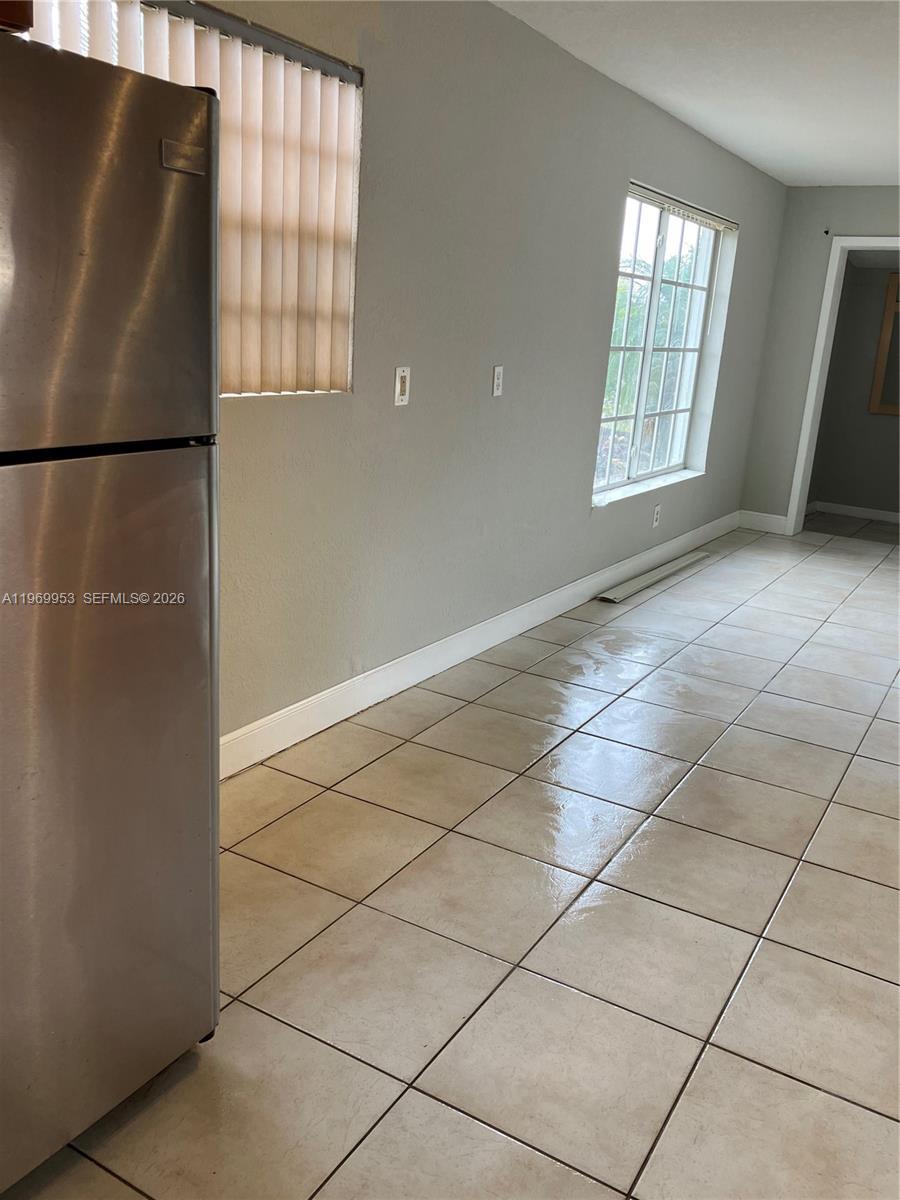 5730 Southwest 37th Street Davie, FL 33314 - Photo 16 of 20 an empty room with windows and refrigerator