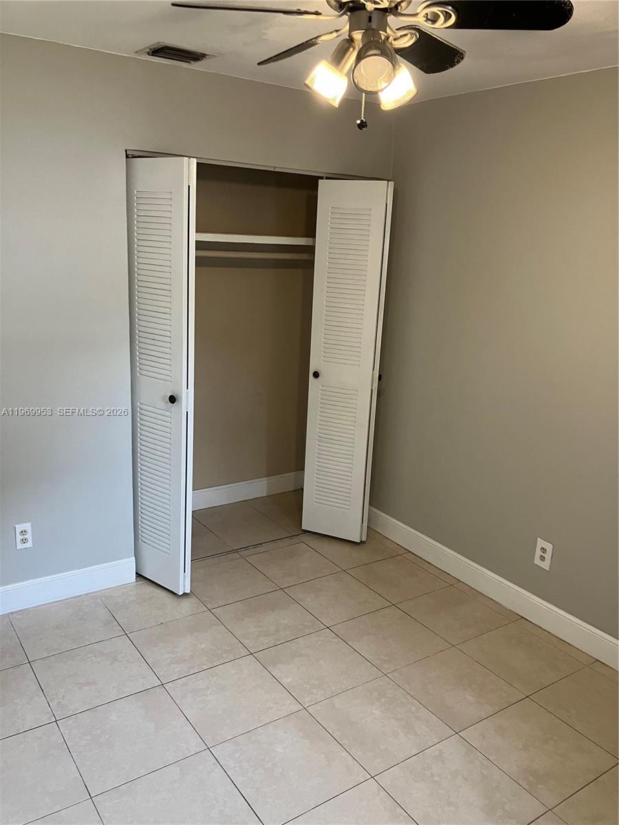 5730 Southwest 37th Street Davie, FL 33314 - Photo 9 of 20 an empty room with closet and chandelier fan