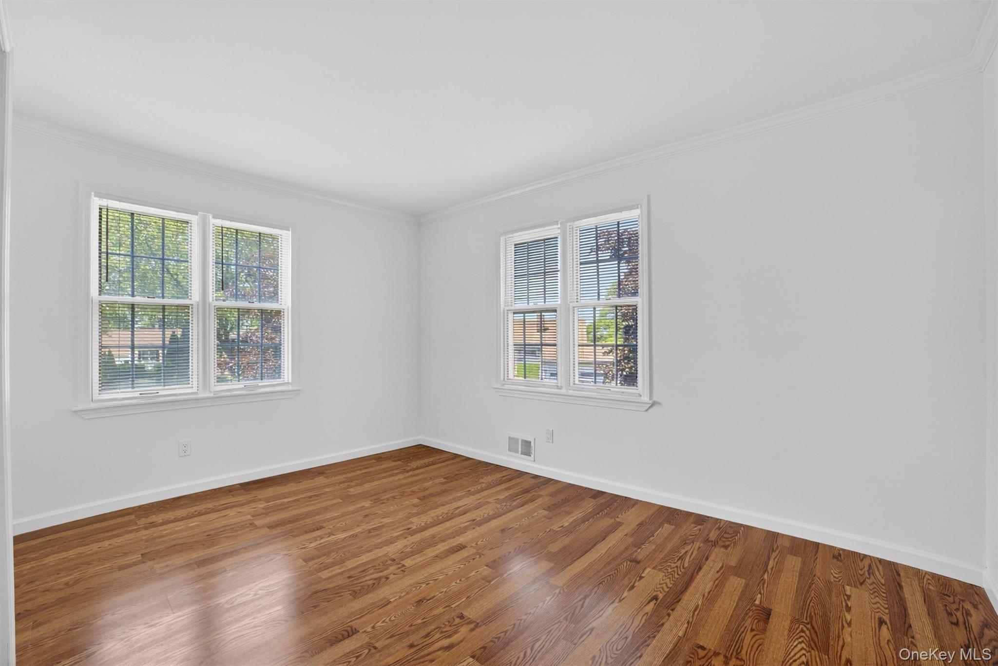 263 Croydon Road Yonkers, NY 10710 - Photo 25 of 43 an empty room with wooden floor and windows