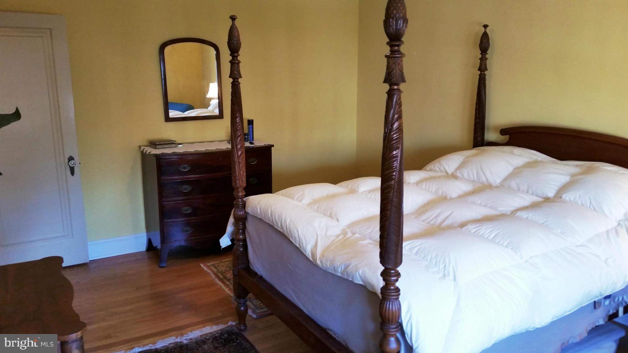 225 Hopkins Road Baltimore, MD 21212 - Photo 13 of 28 a bedroom with a bed and a dresser