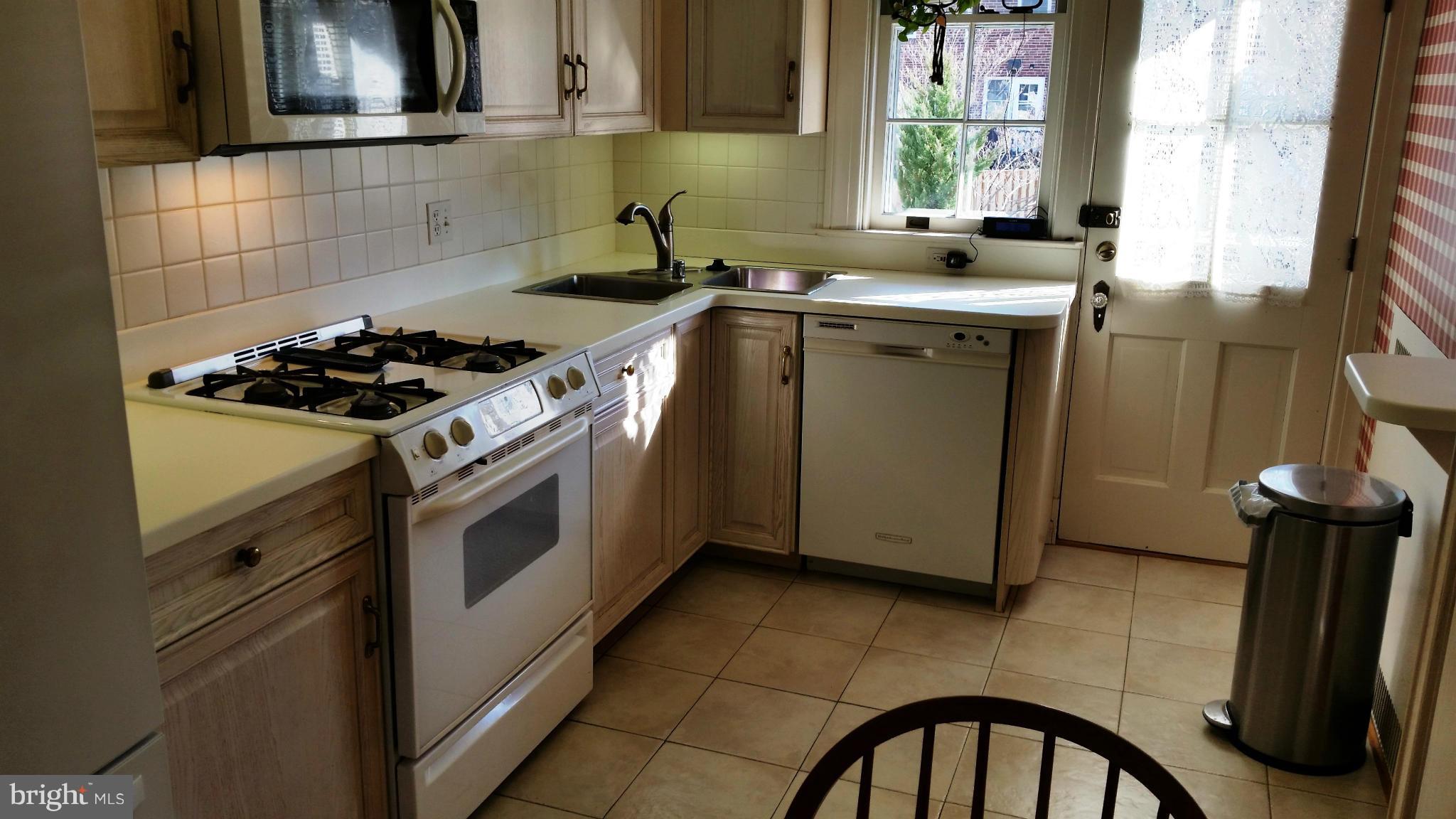 225 Hopkins Road Baltimore, MD 21212 - Photo 7 of 28 a kitchen with a stove a sink and a window