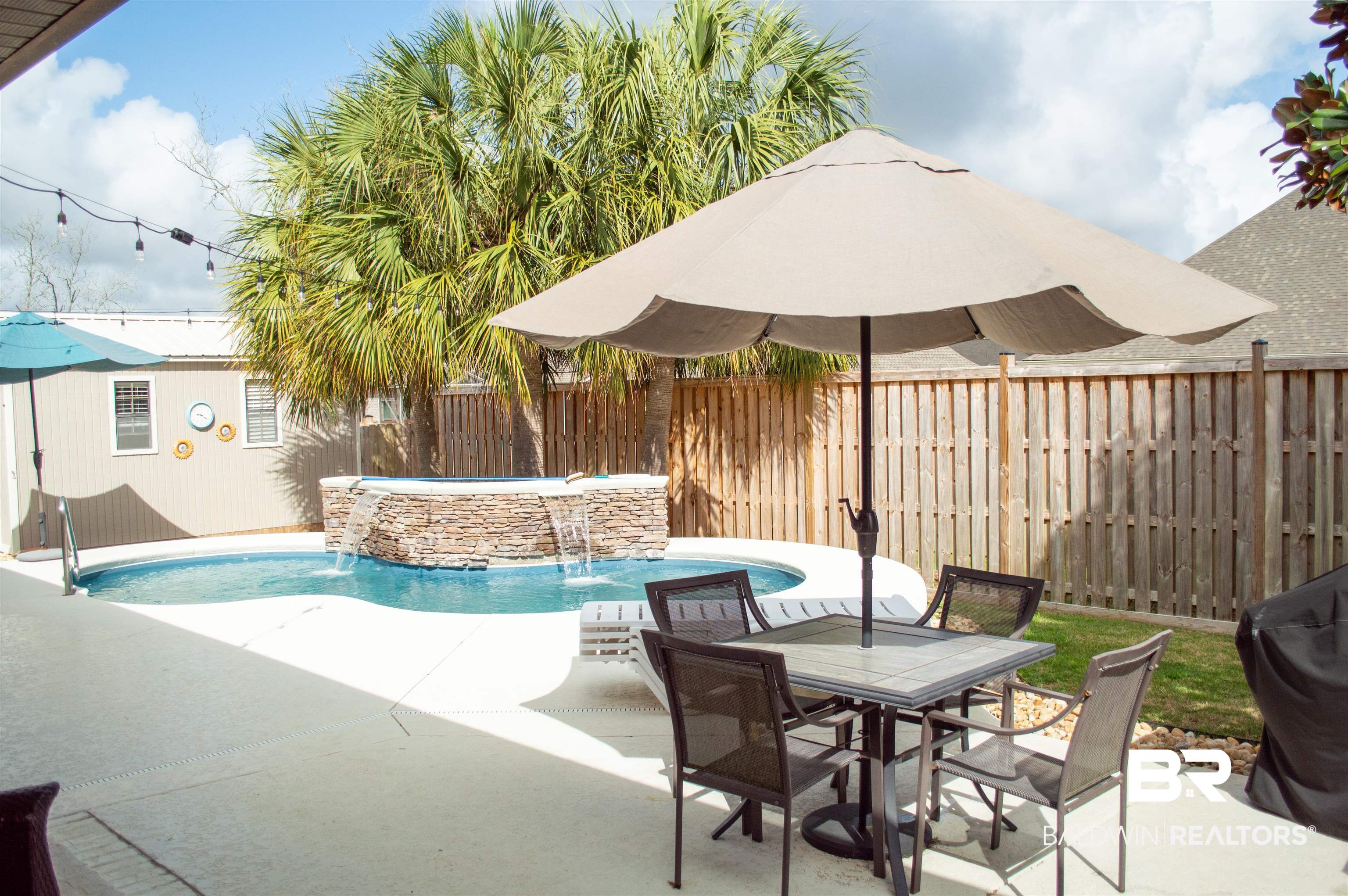1124 West Orlando Drive Foley, AL 36535 - Photo 45 of 51 View of pool with patio surround, a fenced backyard, and an in-ground hot tub