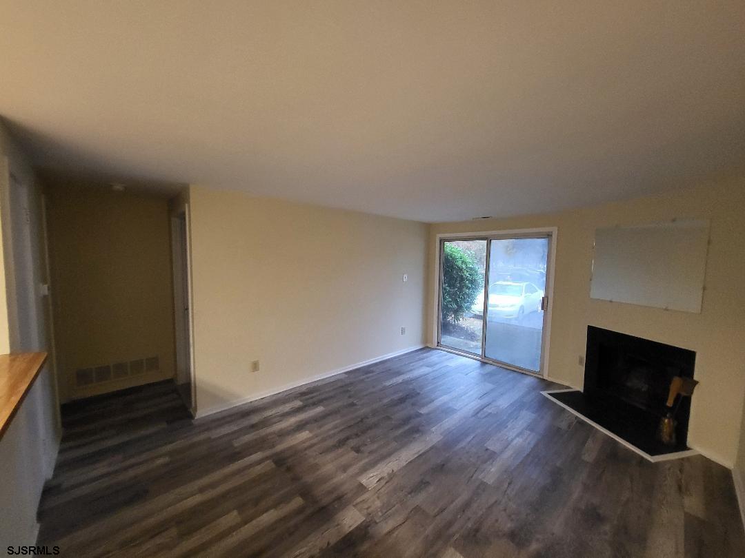 9 Malibu Way, Unit 9 Galloway Township, NJ 08205 - Photo 2 of 6 a view of an empty room with wooden floor and a window
