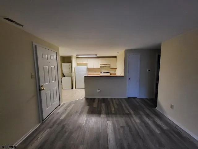 a view of a kitchen from a hallway