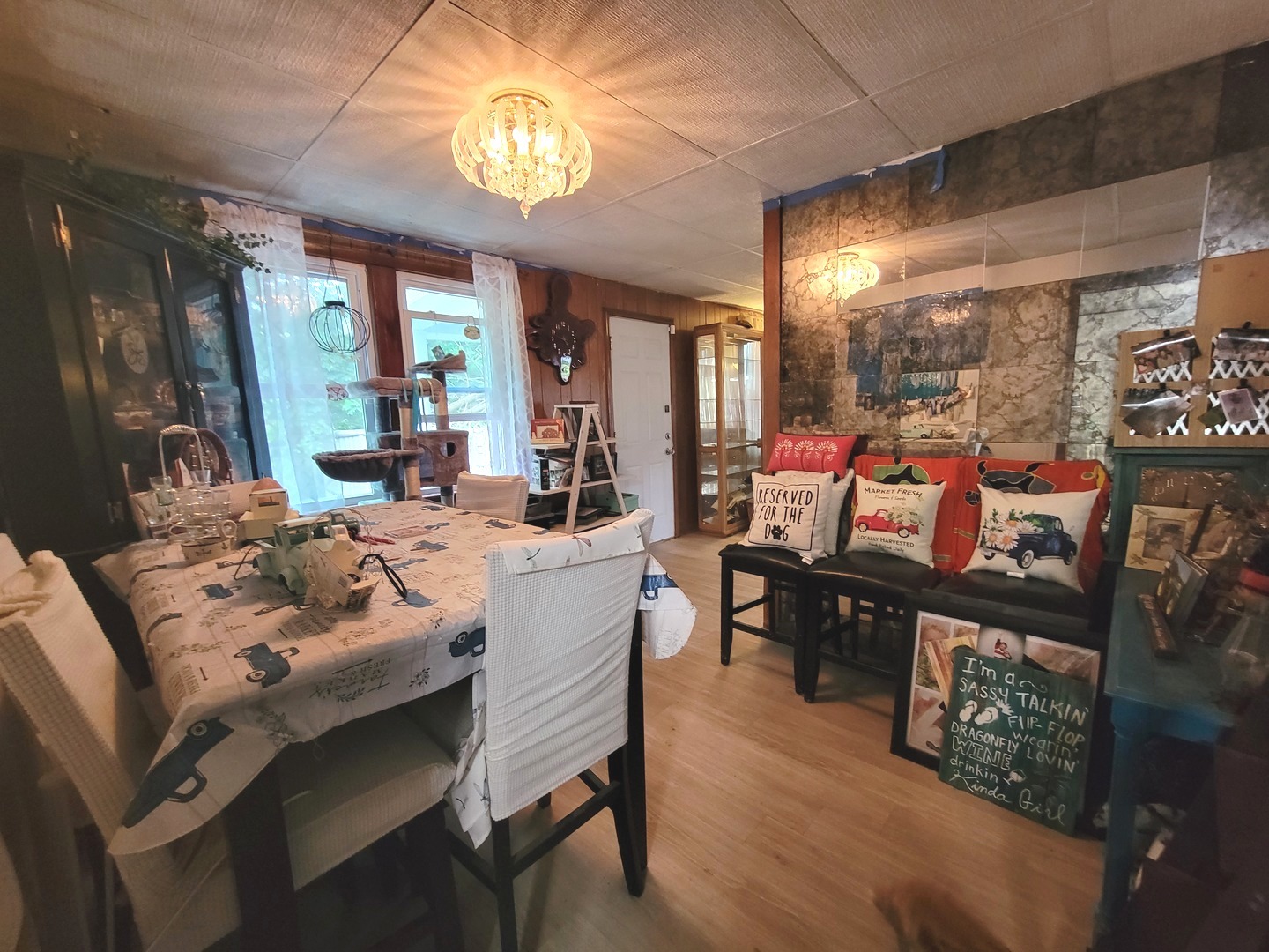 783 North 2853rd Road Utica, IL 61373 - Photo 17 of 26 a view of a dining room with furniture a chandelier windows and wooden floor