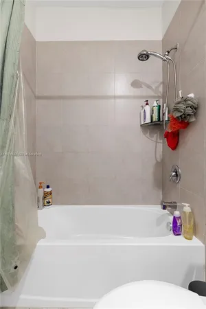 a bathroom with a bathtub a shower and a bathtub