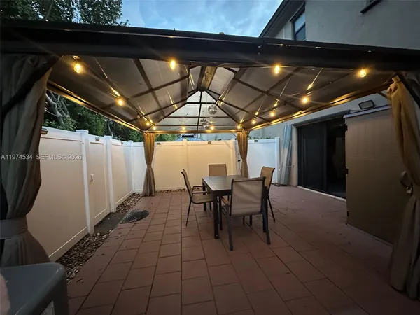 a view of a chairs and table in the patio