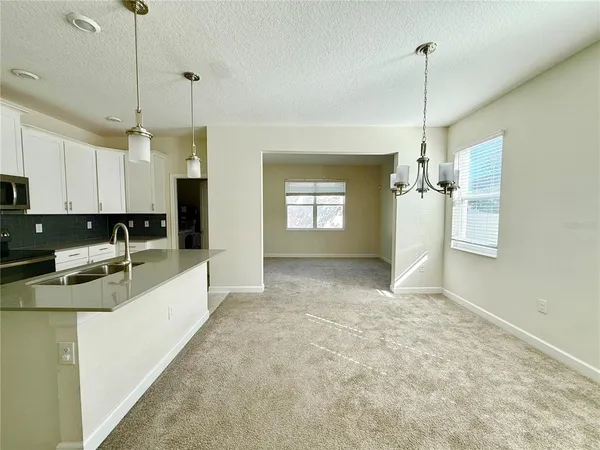 a view of a kitchen with a stove and chandelier