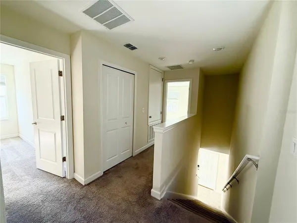 an entryway with wooden floor and cabinet