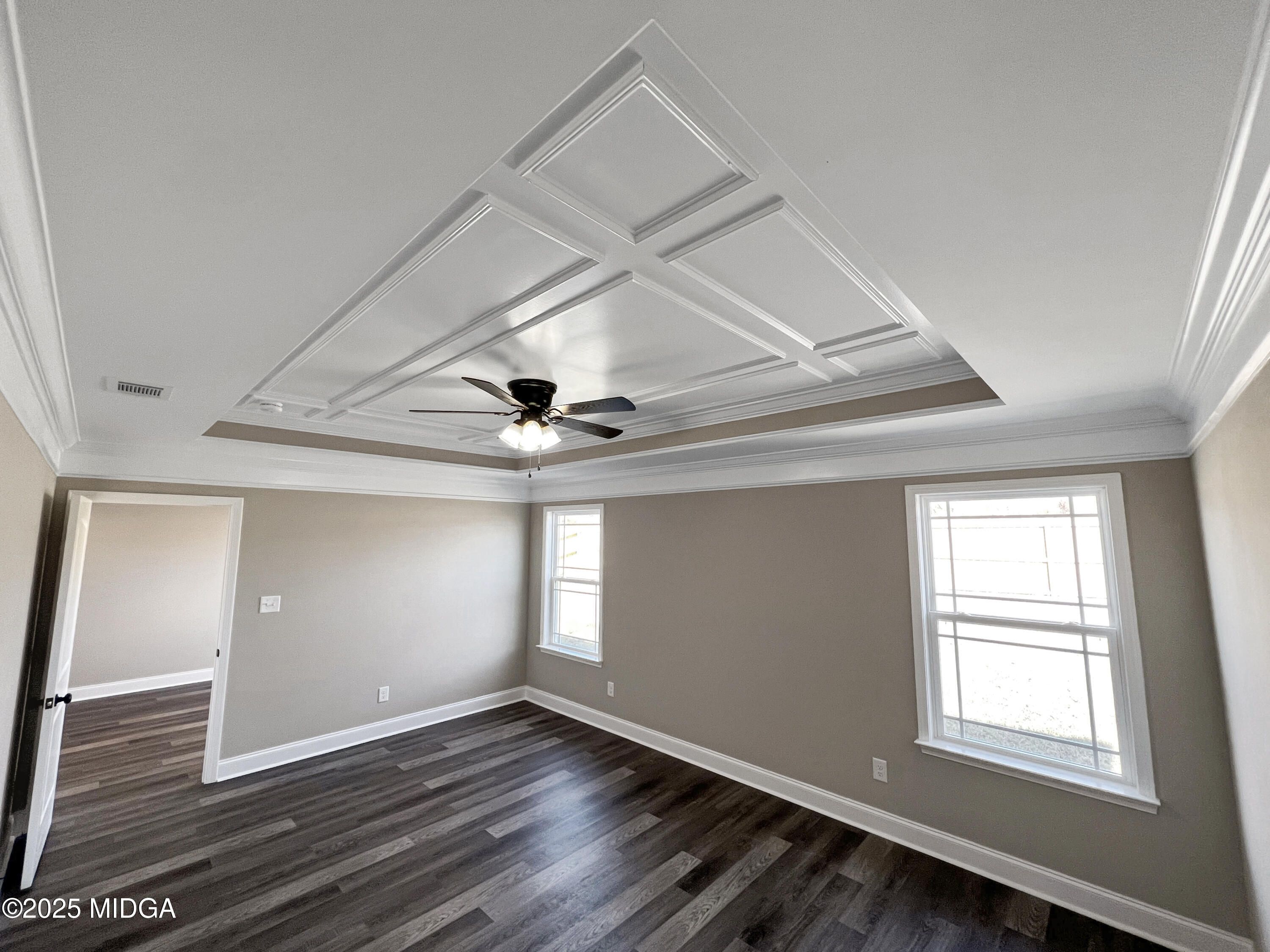 204 Eric Court Byron, GA 31008 - Photo 6 of 10 a view of an empty room with wooden floor and a window