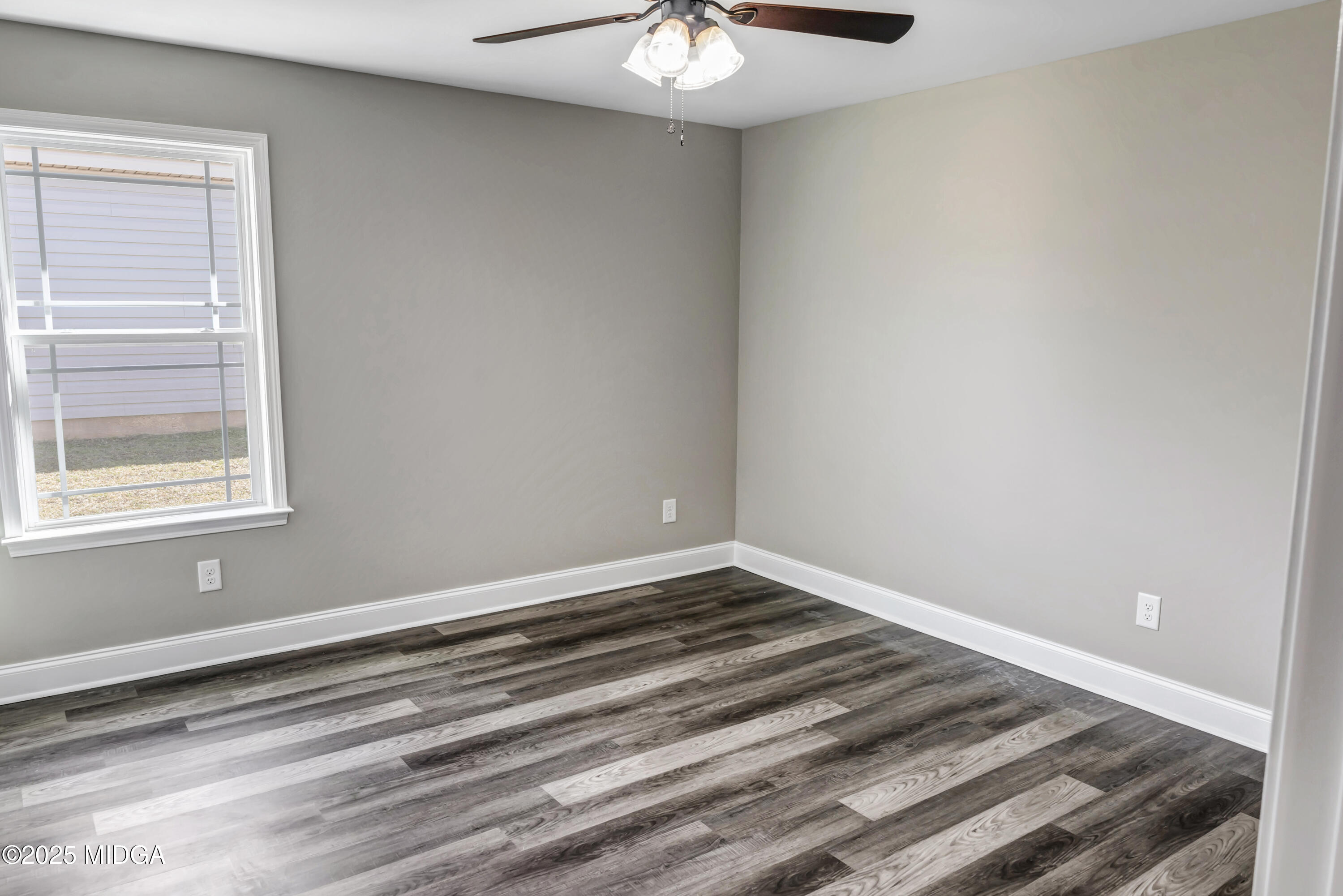 204 Eric Court Byron, GA 31008 - Photo 8 of 10 a view of a room that has a window and wooden floor