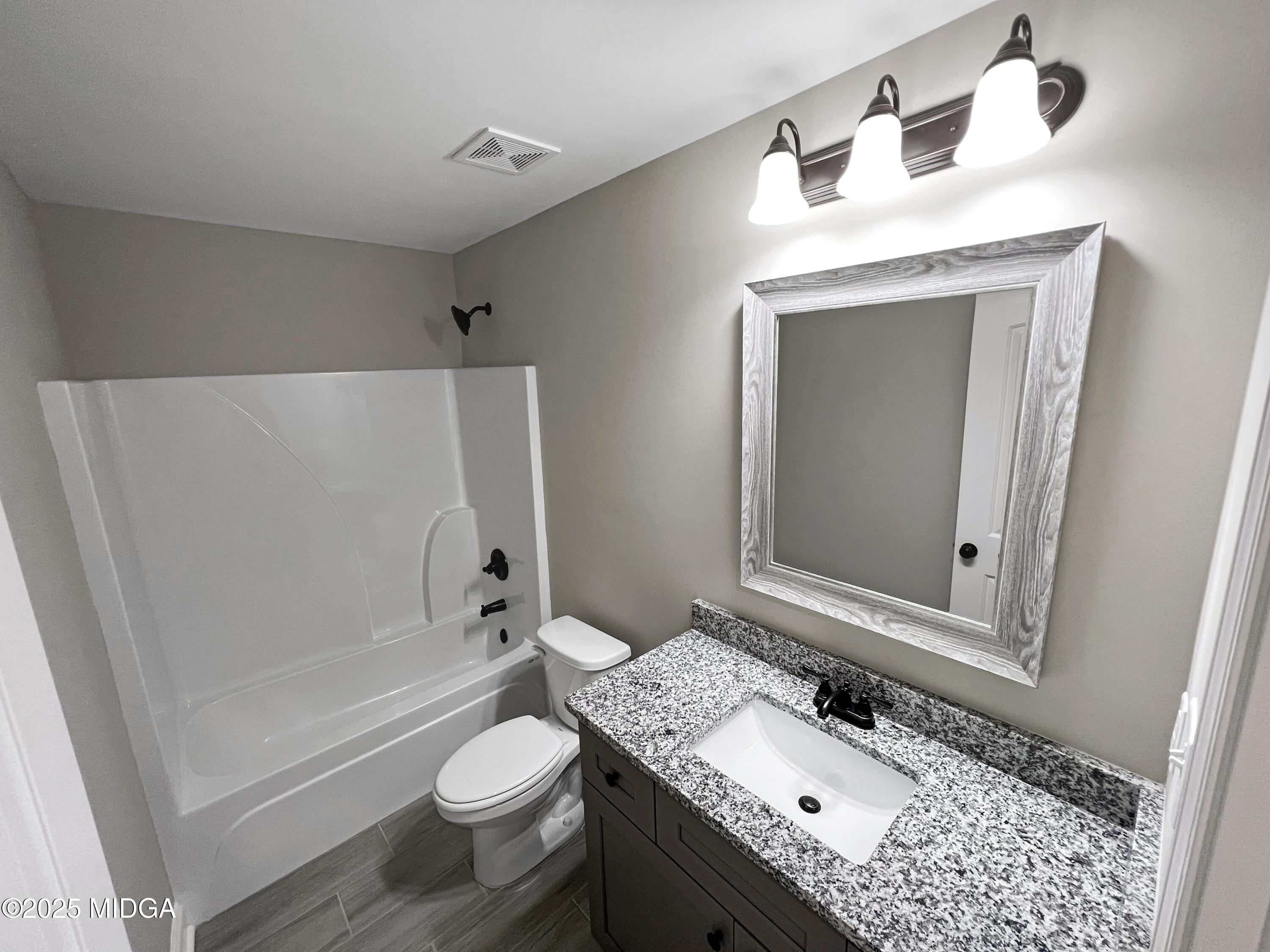 204 Eric Court Byron, GA 31008 - Photo 9 of 10 a bathroom with a granite countertop sink toilet and shower