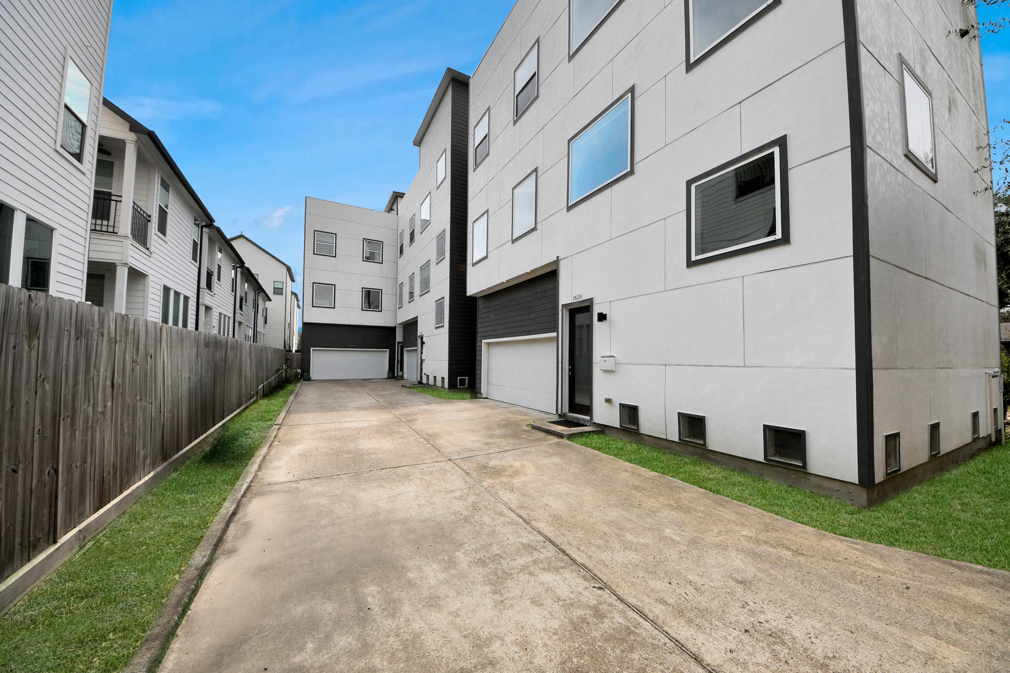 1628 West 24th Street Houston, TX 77008 - Photo 33 of 41 This modern home offers a unique blend of privacy and community, sharing a driveway with only two other residences, ensuring a tranquil living experience.
