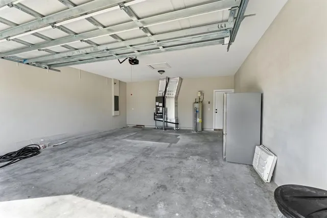 a view of a room with stainless steel appliances wooden floor and chandelier