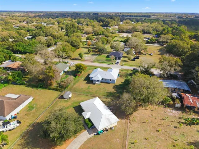 an aerial view of residential houses with outdoor space
