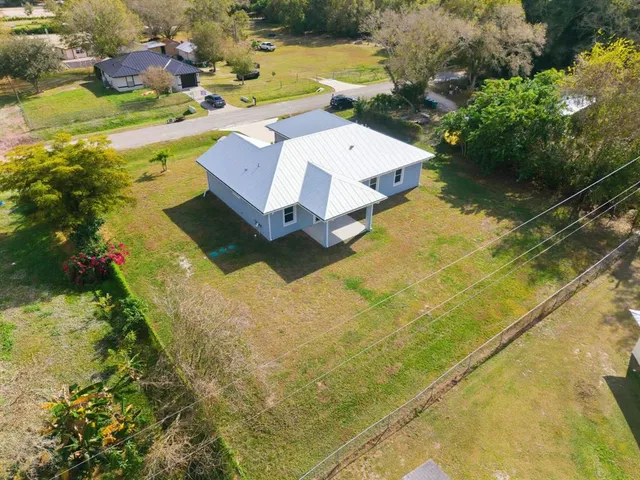an aerial view of a house with swimming pool