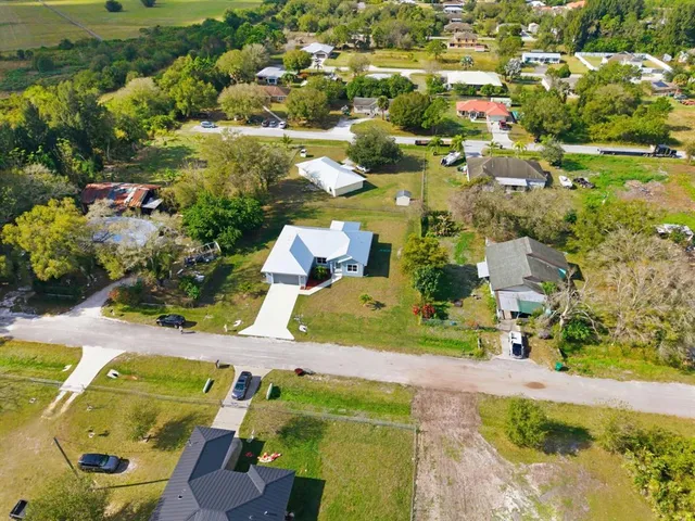 an aerial view of residential houses with outdoor space and swimming pool