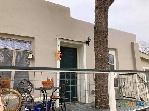 a balcony with table and chairs
