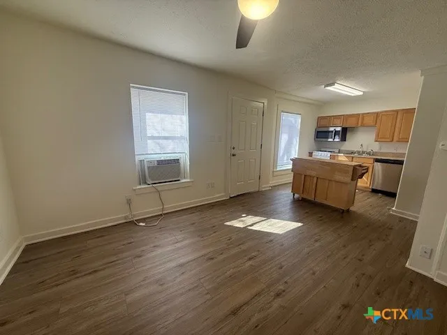 a room with a wooden floor and chandelier