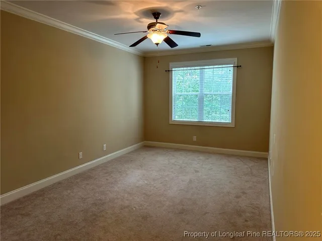 a view of a room with a ceiling fan and a window