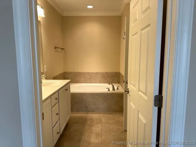 a bathroom with a tub sink and mirror