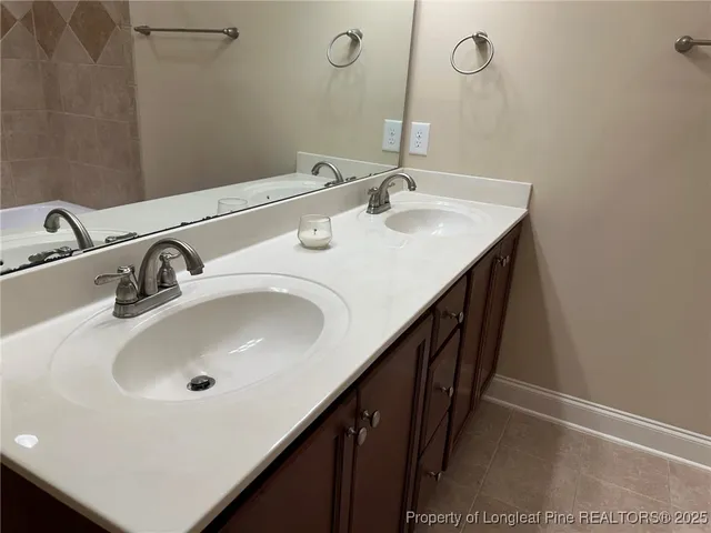 a bathroom with a double vanity sink and a mirror