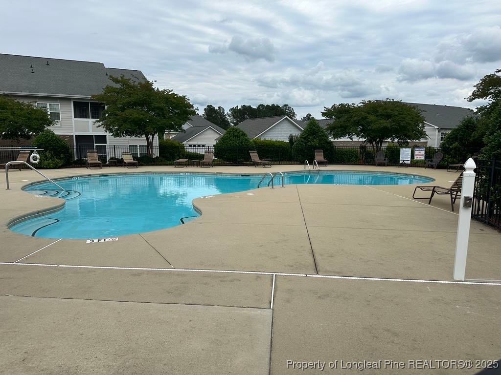 158 Gallery Drive, Unit 202 Spring Lake, NC 28390 - Photo 22 of 22 a view of a swimming pool and lounge chair