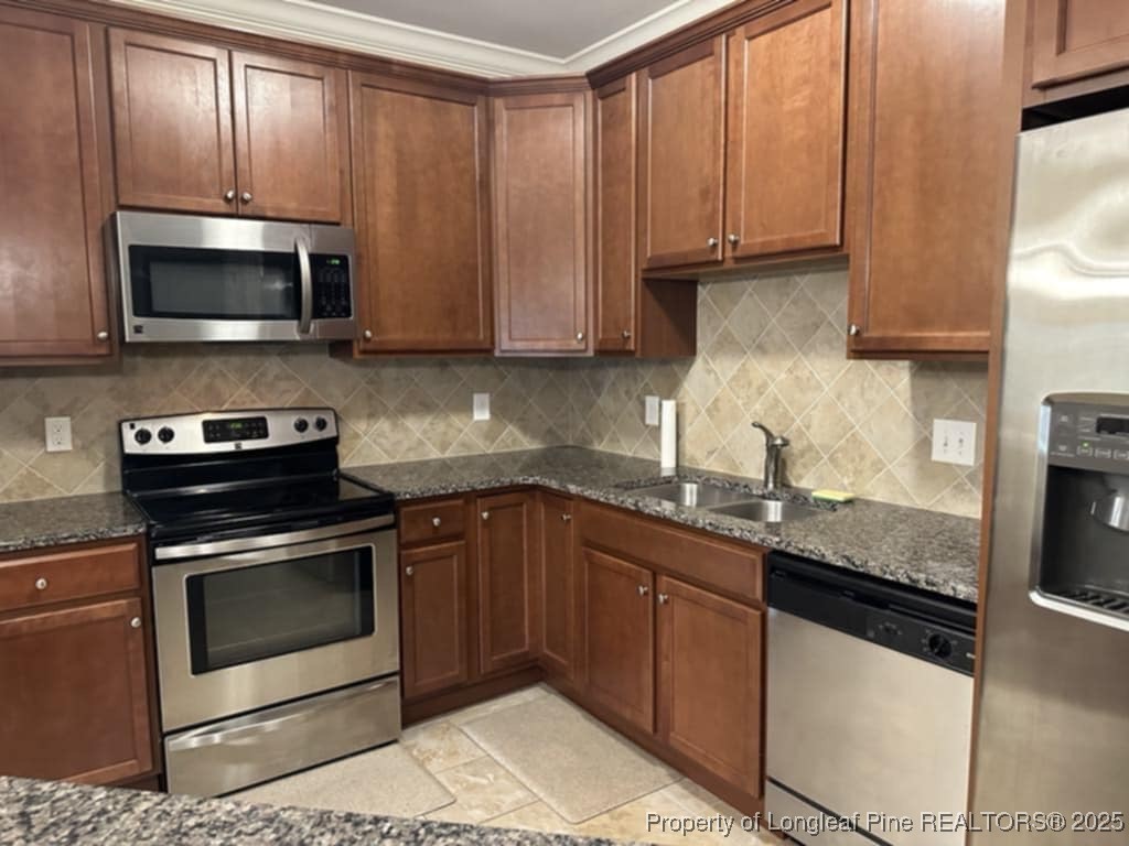 158 Gallery Drive, Unit 202 Spring Lake, NC 28390 - Photo 6 of 22 a kitchen with granite countertop wood cabinets stainless steel appliances and a sink