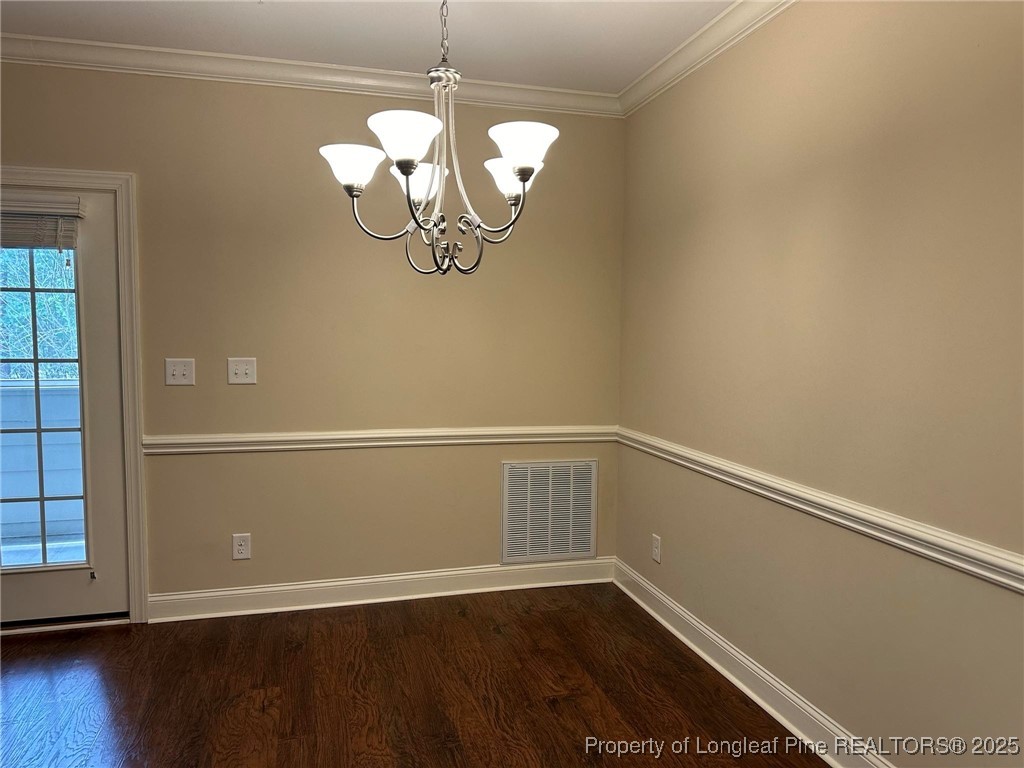 158 Gallery Drive, Unit 202 Spring Lake, NC 28390 - Photo 10 of 22 an empty room with wooden floor chandelier and windows