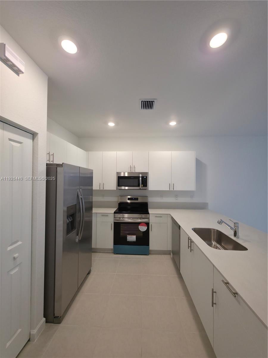 35687 Southwest 178th Court Homestead, FL 33034 - Photo 7 of 28 a kitchen with a refrigerator and a sink