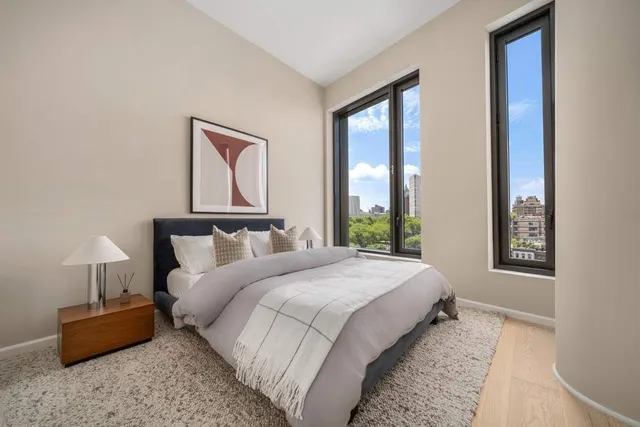 a bedroom with bed and a night stand