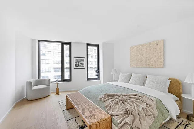 a bedroom with a bed and glass windows