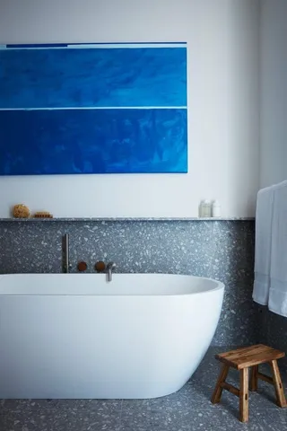 a white bath tub sitting in a bathroom